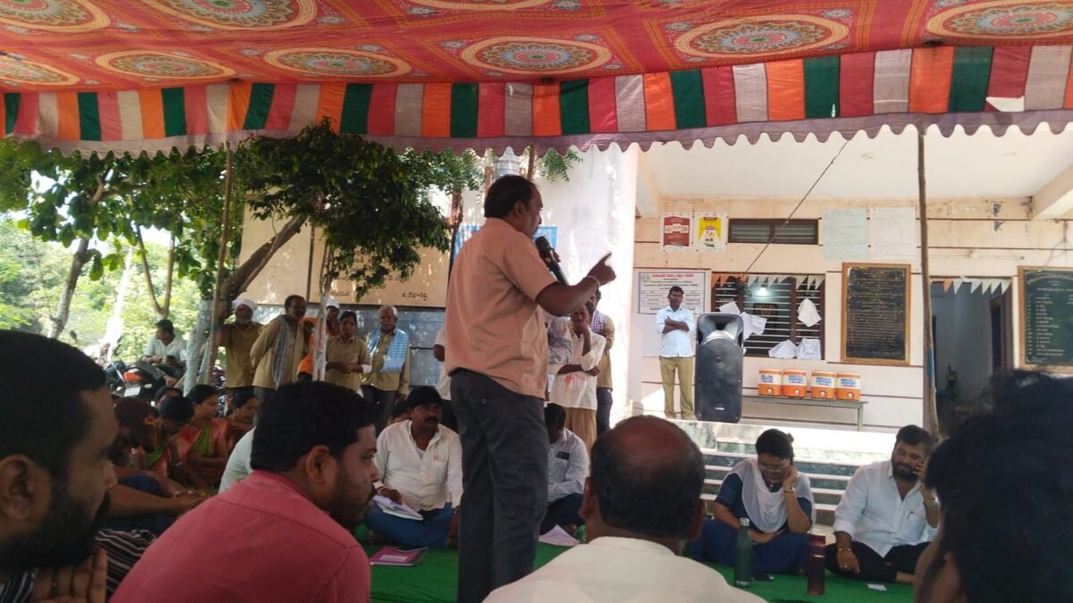 Speaker addressing people during a public meeting under a decorated tent